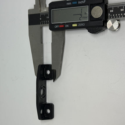 Metal bracket being measured with a digital caliper on a white background. Part number  223 - Amesbury Truth Awning Narrow Operator Bracket width measurement 1/2 inch 