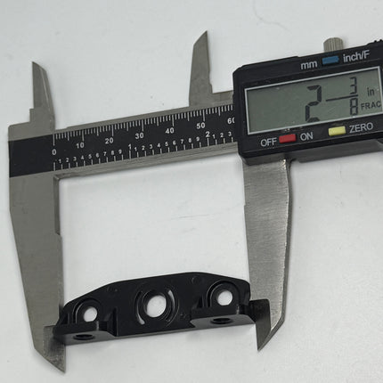 Digital caliper measuring a black metal bracket on a white background. Amesbury Truth Awning Narrow Operator Bracket 2 2/8 inch  long