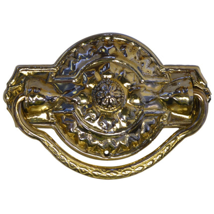 Colonial Revival Drawer Pull. Featuring a rounded shape with ornate detailing, this pull has a stamped brass back plate and a cast brass handle. It includes a machine screw and escutcheon pin for easy mounting via the single central post. The back plate measures 1 7/8" x 3". in Brass  finish.