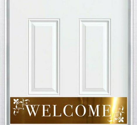 White door with a gold 'WELCOME' kick plate