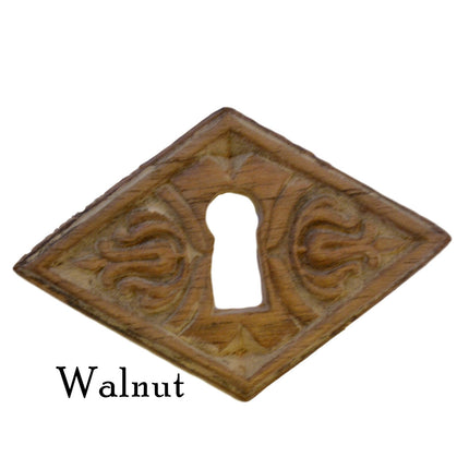 Diamond-shaped embossed wooden keyhole covers, made of walnut wood brown in color with intricate embossed patterns.