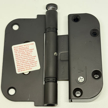 Matt black door hinge on white background. Sticker on hinge has instructions on how to adjust 850-8762439 - S4009 HTL Ultimate 2-D Hinge - Hoppe Set Hinge Adjustable. Part Number850-8762439 and Pat. Nr. 5701636, Pat. Nr. 5,701,636 Color Matt black 
