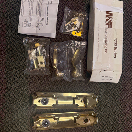 Door hardware set with packaging on a textured surface. W&F 1200 Series Handle Set 6" Center to Center Bore .Double Island Escutcheon Versailles Handles known part number 13-283BBK-1
